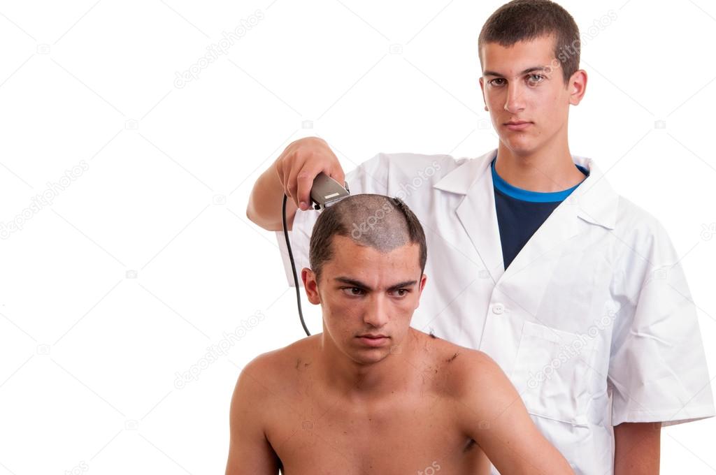 Man having a haircut with a hair clippers over a white backgroun
