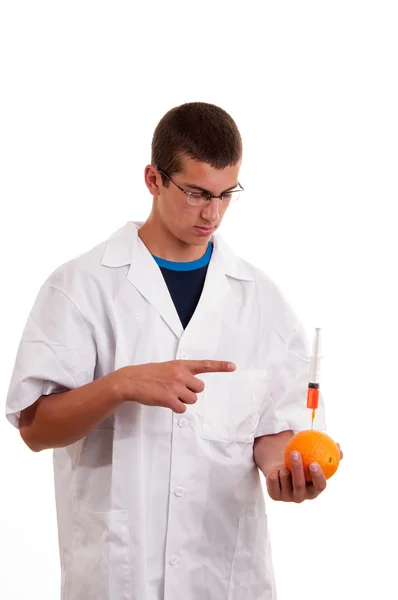 Injection into fruits. Genetically modified fruit with syringe b — Stock Photo, Image