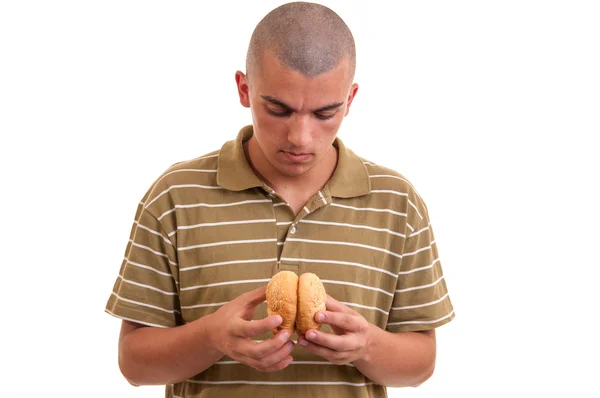 Young man is holding two rolls with sesame and prepares to eat t — Stock Photo, Image