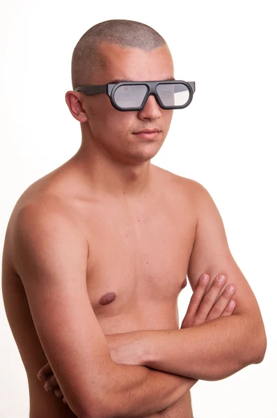 Serious young man wearing 3D glasses and stand with hands cross — Stock Photo, Image