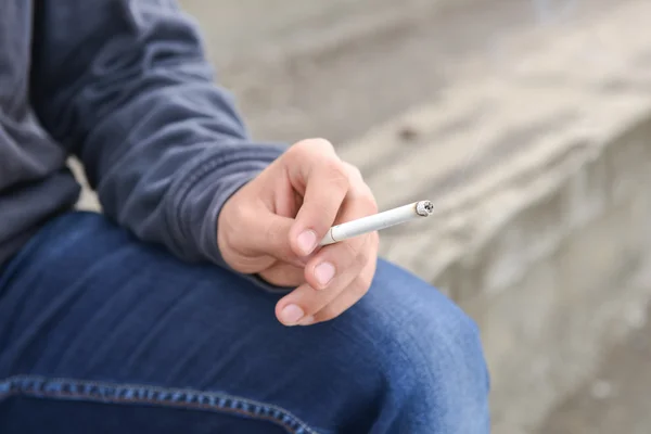 Young male hand holding a cigarette — Stock Photo, Image