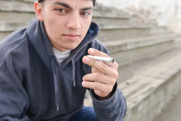 Teenage boy smoking cigarette outdoor. Concept of young people w — Stock Photo, Image