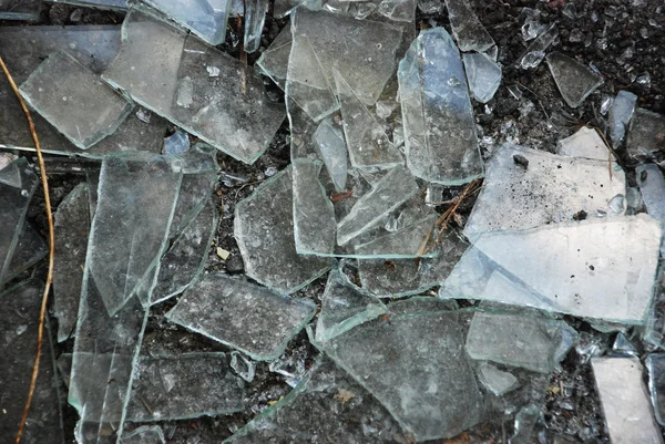Broken glass over grey background. — Stock Photo, Image