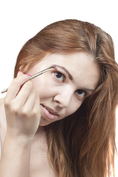 The girl does makeup. — Stock Photo, Image