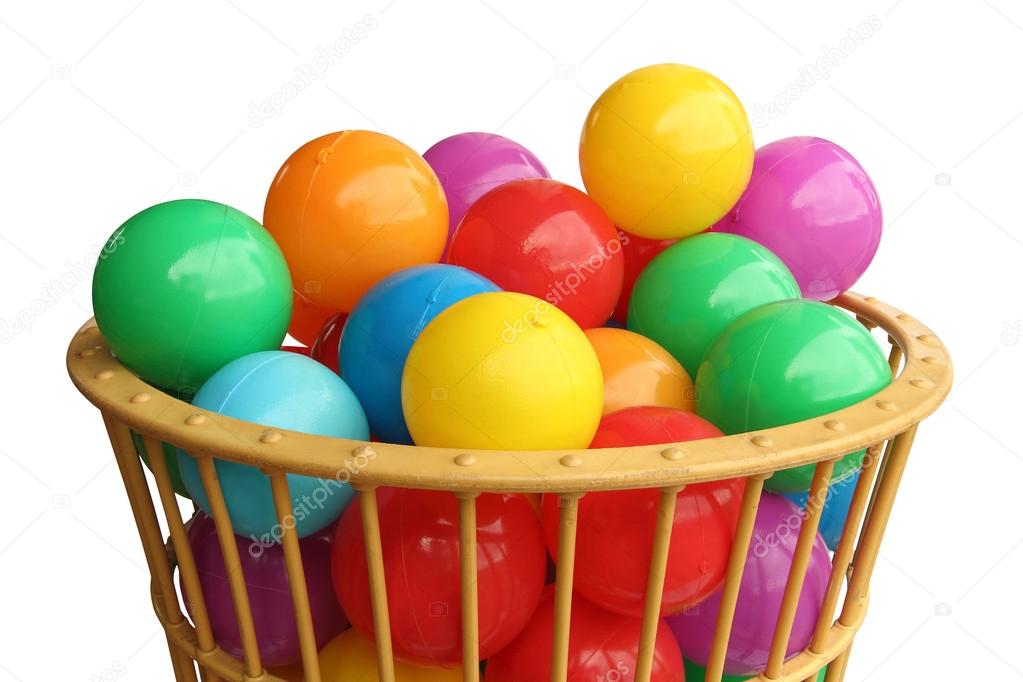 Colour plastic balls in basket over white background