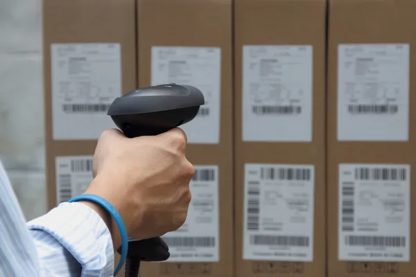 Scanning the label on the boxes with barcode scanner — Stock Photo, Image