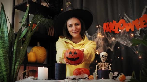 Веселая красивая девушка с тыквой в руках, празднующая Хэллоуин. Хэллоуин — стоковое видео