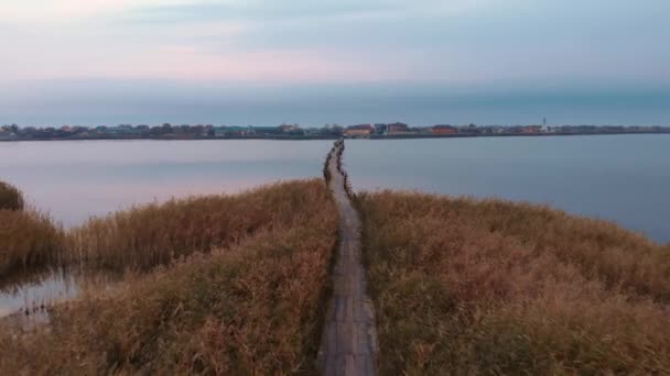 Empty bridge through lake. Beautiful sunrise at estuary. Calm water surface at sunset — Stock Video