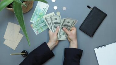 El sayımı 100 dolarlık banknotlar. Elinde para olan bir kadın.
