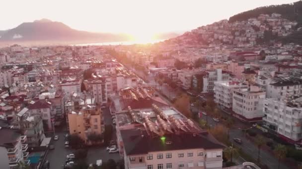 Beautiful cityscape on shores of blue Mediterranean sea at sunrise. City on rocky coast at sunset — стокове відео