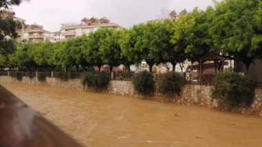 Water pollution. Dirty river with muddy brown water in flooding period during heavy rains