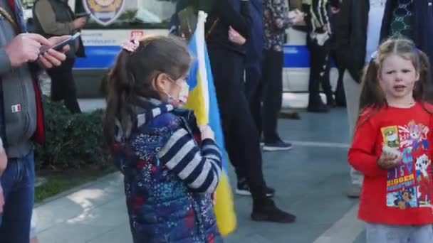 Kleines Mädchen mit Nationalflagge der Ukraine beim Protest gegen die russische Invasion in der Ukraine: Alanya, Türkei - 26.02.2022 — Stockvideo