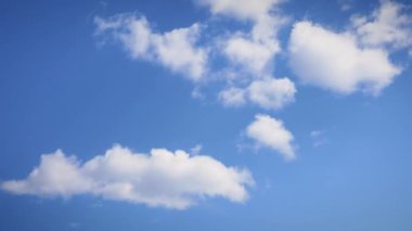Mavi gökyüzüne karşı güzel bulutlar, zaman geçişi. Bulutlar hızla gökyüzüne doğru ilerliyor