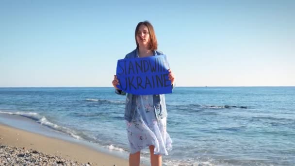 Donna con striscione Stand With Ukraine, protesta contro la guerra con la Russia — Video Stock