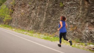 Dışarıda koşan bir kadın. Kadın koşuyor ve spor fitness hedeflerine ulaşıyor