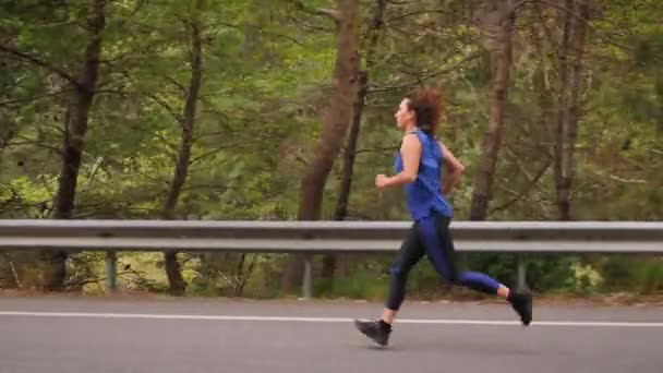Kvinnan springer fort, pressar sig själv för sitt sportiga maximum. Aktiv idrott — Stockvideo