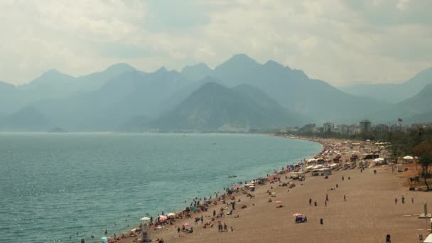 People on beach in summer day. Summertime at Mediterranean coastline — Stock Video
