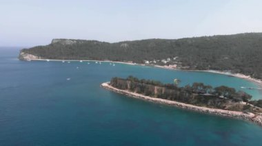 Calm blue lagoon surrounded by green tree mountains.Natural parkland with lagoon