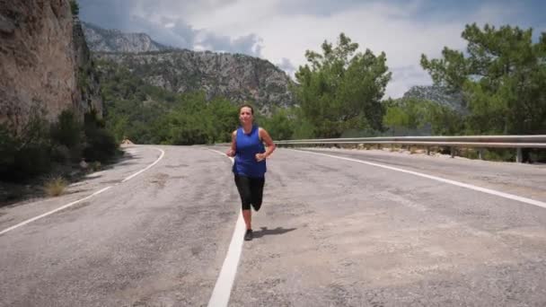 Energetic active woman running in mountains. Fitness recreation activity — Vídeo de stock