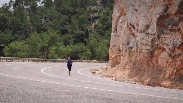 Mañana trotando en las montañas. Mujer atlética enérgica haciendo ejercicio al aire libre — Vídeo de stock