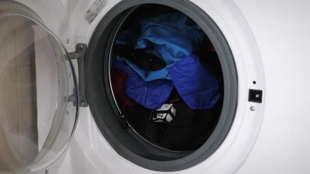 女性关闭洗衣机门与肮脏的衣服 女人在家里打扫卫生女人在家里用洗衣机洗衣服 — 图库视频影像