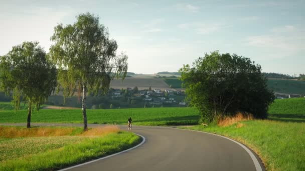 Road Cyclist Speeding Mountain Road Female Cyclist Riding Bicycle Empty — Stockvideo