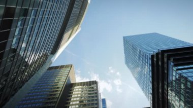 Time lapse of tall corporate buildings skyscrapers against blue sky and white clouds, low angle. Modern business office buildings tops against fast moving clouds. Business and construction concept