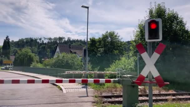 Modern Red Passenger Train Crossing Railway Barrier Which Block Road — Vídeo de Stock