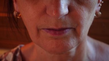 Mouth of elderly female pulls upper jaw out of mouth. Artificial teeth. Dentures