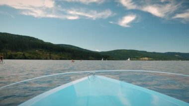 Sailing yacht boat driving along lake on sunny day. Electric boat floating on water. Summer relax vacation. Travel and tourism concept.  Holiday weekend. Sailing concept