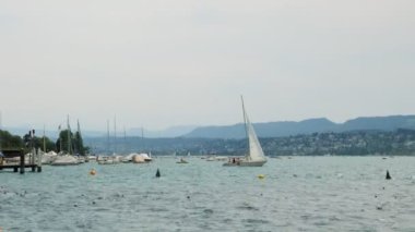 Regatta on lake in Zurich. Luxury white yachts moored in marina on lake in Zurich city. Zurich city waterfront in Switzerland. Popular travel destinations. Summer vacation concept. Tourism concept