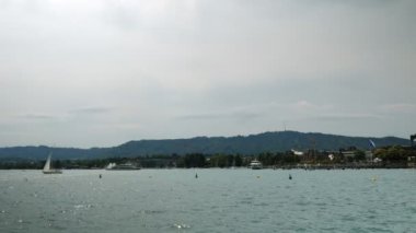 Tourist ships sailing on lake in Zurich. Boats and yachts floating along beautiful Zurich Lake in Switzerland. Popular travel destinations. Boats cruising along lake with green hills on horizon