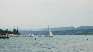 Sailing boats on water on Zurich Lake. Beautiful lake in Zurich with floating ships and yachts on water. Summer vacation and leisure activity