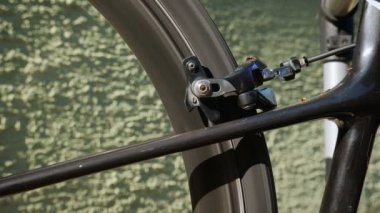 Bicycle brake pads in details. Rotating bike wheel, close up. Bike maintenance workshop. Bike service, repairing. Bicycle wheel details. Bicycle maintenance