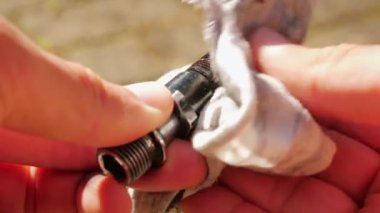 Mechanic wiping bicycle gear, close up. Hand cleaning bike gear with rag. Repairing and maintenance bike. Bicycle repairing shop