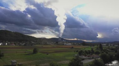 Nuclear power plant with cooling tower. Atomic power station. Industrial zone with emission of steam in air atmosphere. Flying along nuclear power station with river against cloudy rainy sky