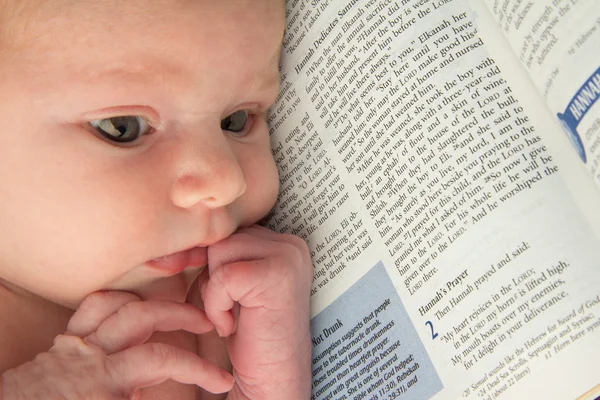 Baby Lies on Scripture of Dedication — Stock Photo, Image