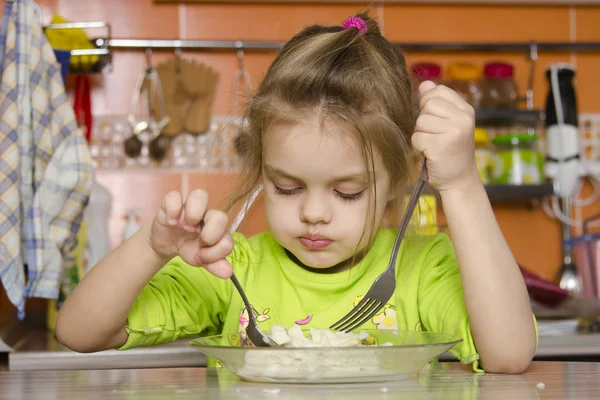 Una bambina di quattro anni mangia con una forchetta — Foto Stock