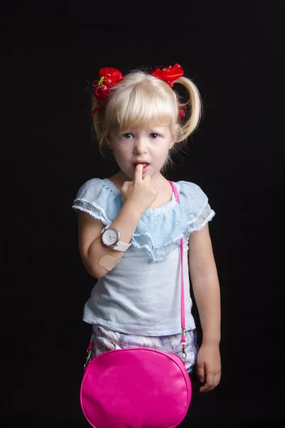 Offended by a little girl with your thumb in your mouth looks into the frame. Portrait — Stock Photo, Image