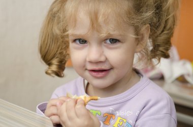 coşku ile küçük kız ve bir rulo zevk ile eats