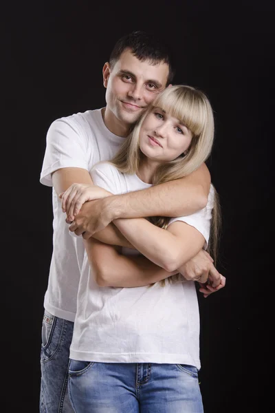 Portrait of a young couple on a black background — Stock Photo, Image