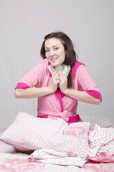 Girl in bed happy obtained money — Stock Photo, Image
