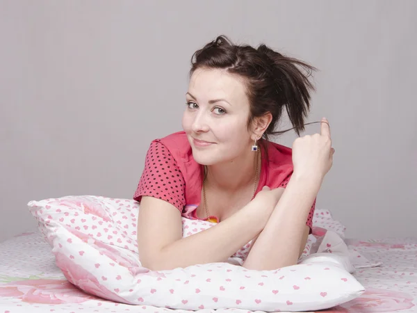 Young beautiful girl dreams in bed — Stock Photo, Image