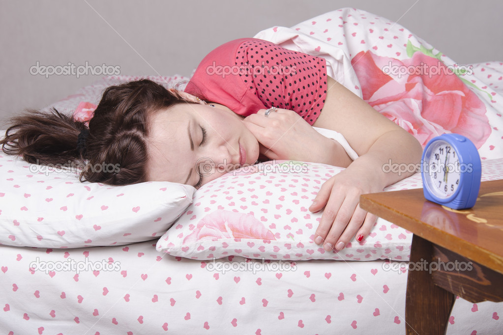 Girl wakes ringing alarm clock