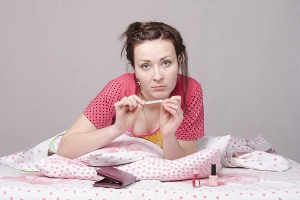 Girl bed engaged in manicure — Stock Photo, Image