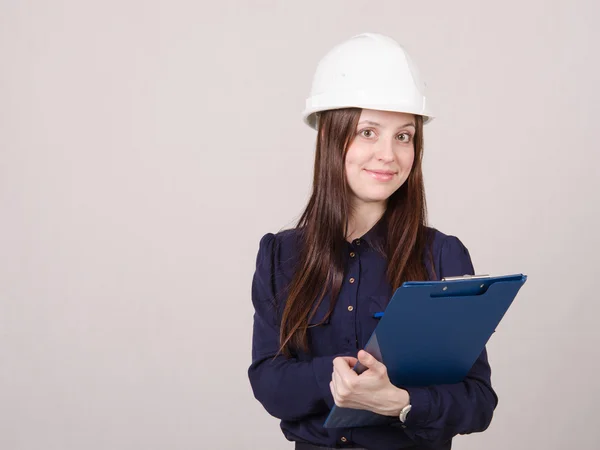 Young woman in helmet records customer's needs — Stock Photo, Image