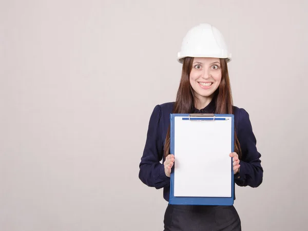 Girl a helmet in shock from inscription on sheet folder — Stock Photo, Image