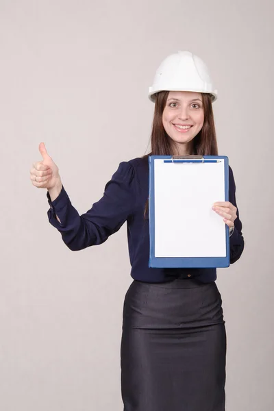 Girl in helmet standing with a folder hand — Stock Photo, Image