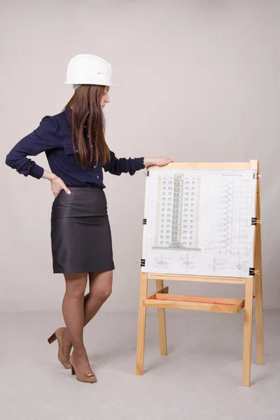 Jonge vrouwelijke student is kijken naar een project meerdere verdiepingen — Stockfoto