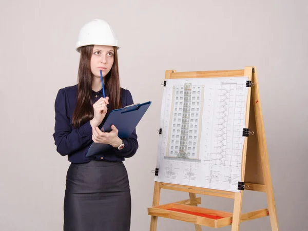 Woman architect on project thought of a multistory building — Stock Photo, Image
